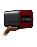 A compact black and red dental curing device held in one hand, with the brand name 'SprintRay' visible.