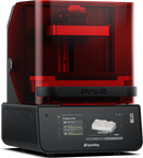 A red SprintRay Pro 2 3D printer designed for dental applications, showing the printer's window allowing light to pass through to the build platform.