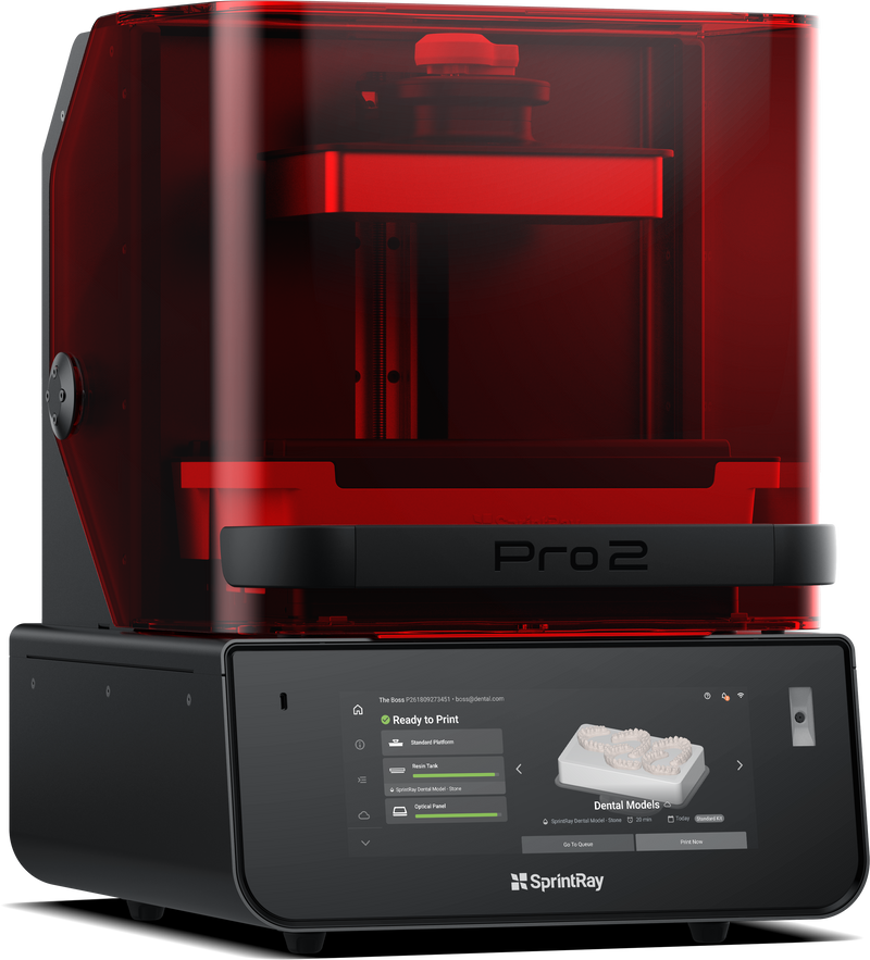 A red SprintRay Pro 2 3D printer designed for dental applications, showing the printer's window allowing light to pass through to the build platform.