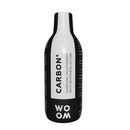 A bottle of mouthwash labeled CARBON+ by WOOM, indicating charcoal mouthwash with teeth whitening properties.