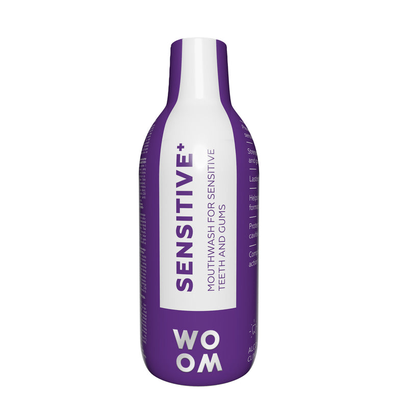 A bottle of mouthwash labeled 'SENSITIVE+' by WOOM, indicating it is formulated for sensitive teeth and gums.