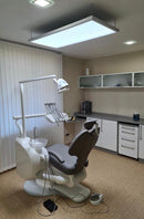 Dental office chair and equipment in a clinical setting with a shadowless lamp pro max dental