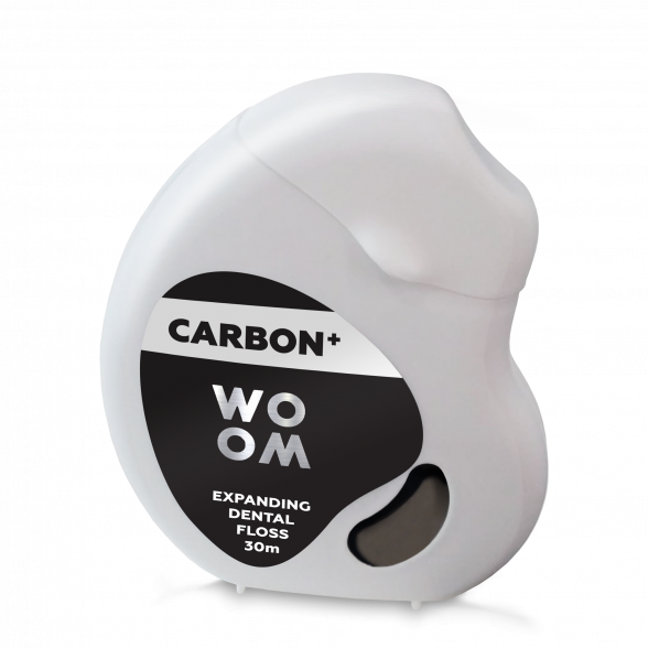 A spool of WOOM Carbon Dental Floss with activated carbon, designed for oral hygiene.