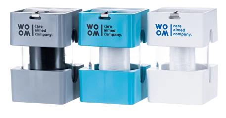 A collection of WOOM dental floss dispensers in various colors (black, blue, white) designed for dental care, with text indicating various features like 'care global company'.