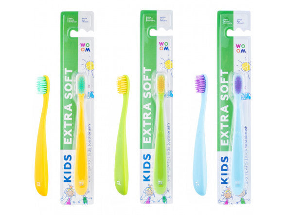 Three kids' toothbrushes with extra soft bristles in packaging, featuring handles in yellow, green, and blue colors.
