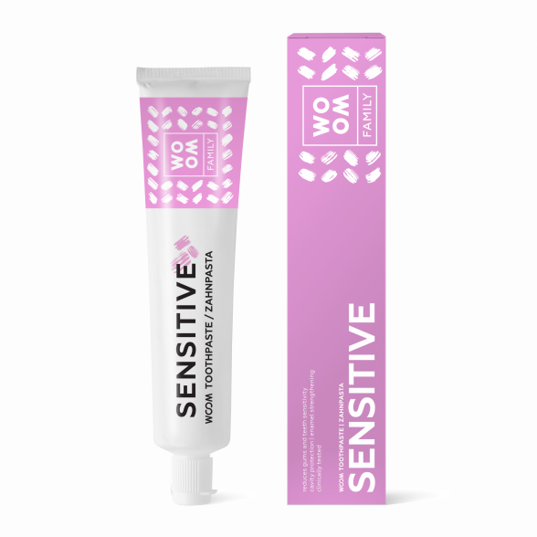 A tube of toothpaste labeled 'SENSITIVE' alongside its packaging box, both featuring a pink and white color scheme with leaf patterns.