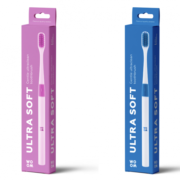 Two toothbrushes in packaging, one with a pink handle and bristles, labeled 'ULTRA SOFT', and one with a blue handle and bristles, also labeled 'ULTRA SOFT'.