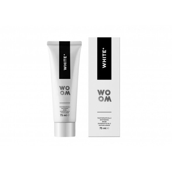 A tube of toothpaste labeled 'WHITE+' next to its packaging box, both featuring the brand WOOM.
